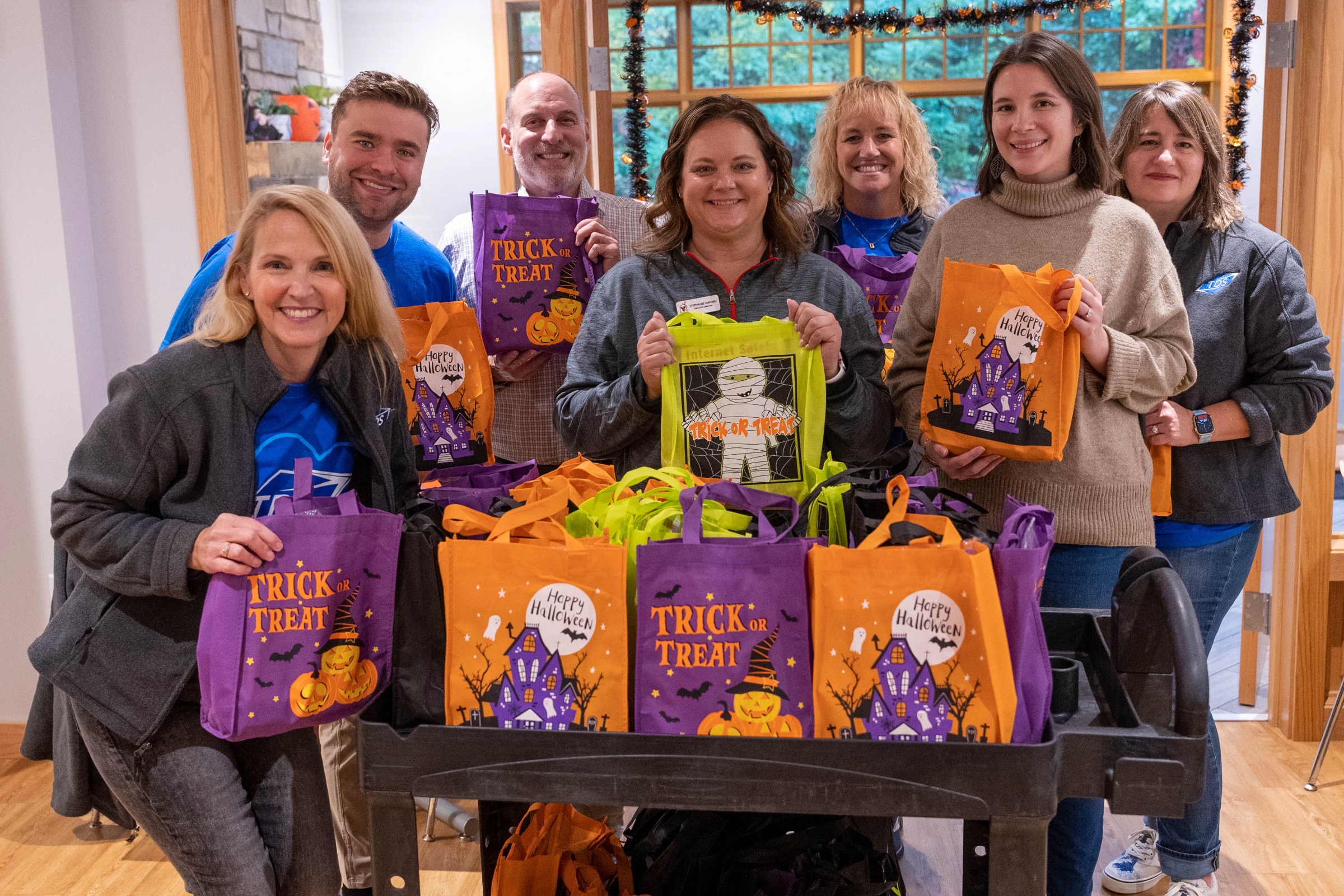 Group of people holding trick or treat bags